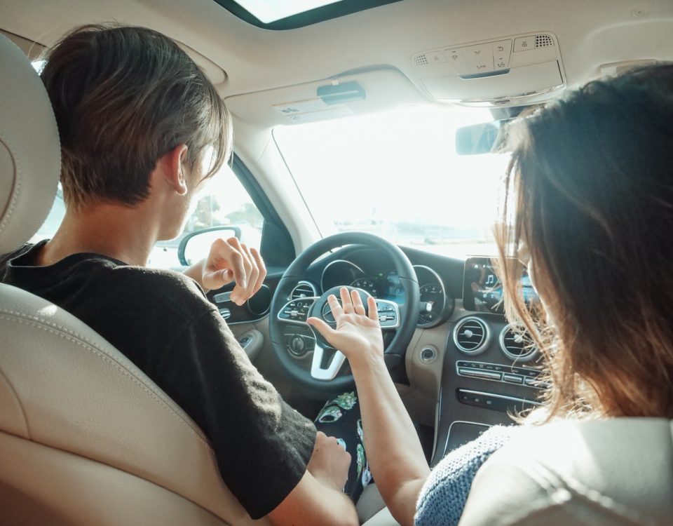 man driving with woman in passenger seat